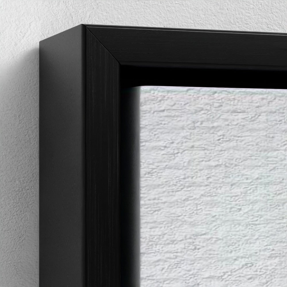 Close-up of a black picture frame corner on a textured white wall.