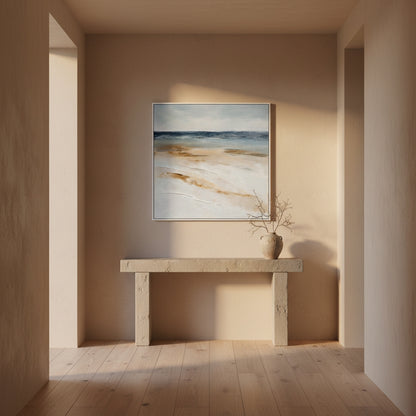 Beige wall with a framed abstract painting and a wooden console table.