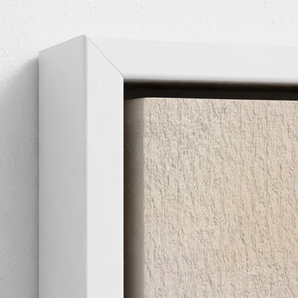 Close-up of a white frame corner on a textured beige surface