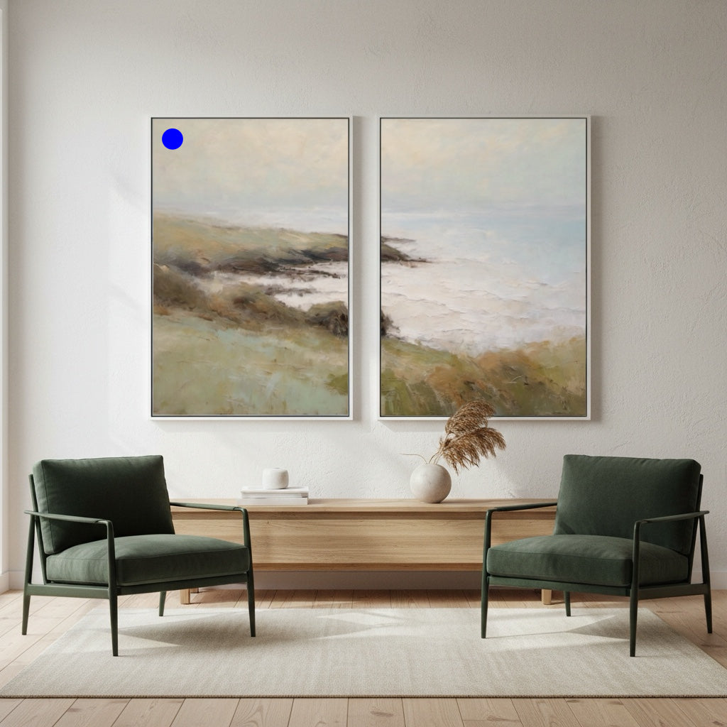 Two green armchairs in a room with two landscape paintings on the wall.