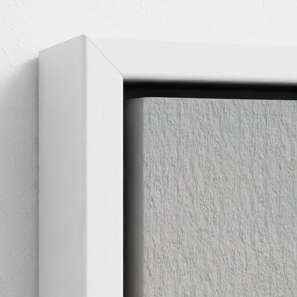 Close-up of a white frame corner on a textured gray surface