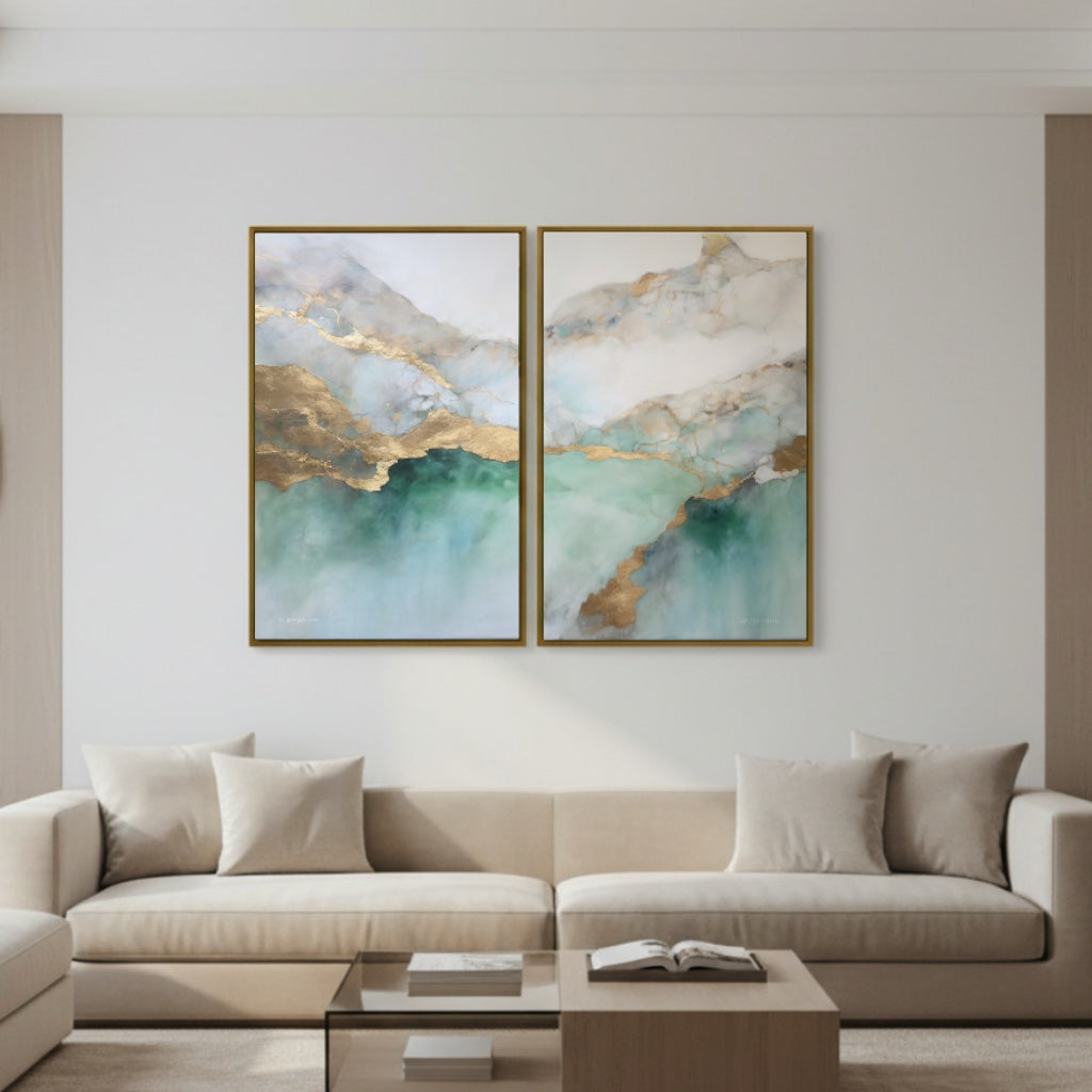 Two abstract paintings on a wall above a beige sofa in a living room.