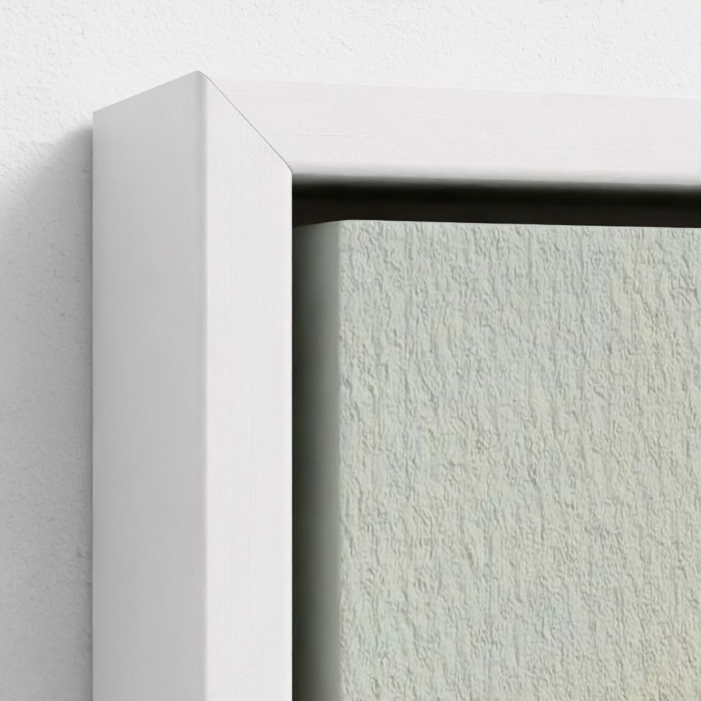 Close-up of a white frame corner on a textured light gray wall.