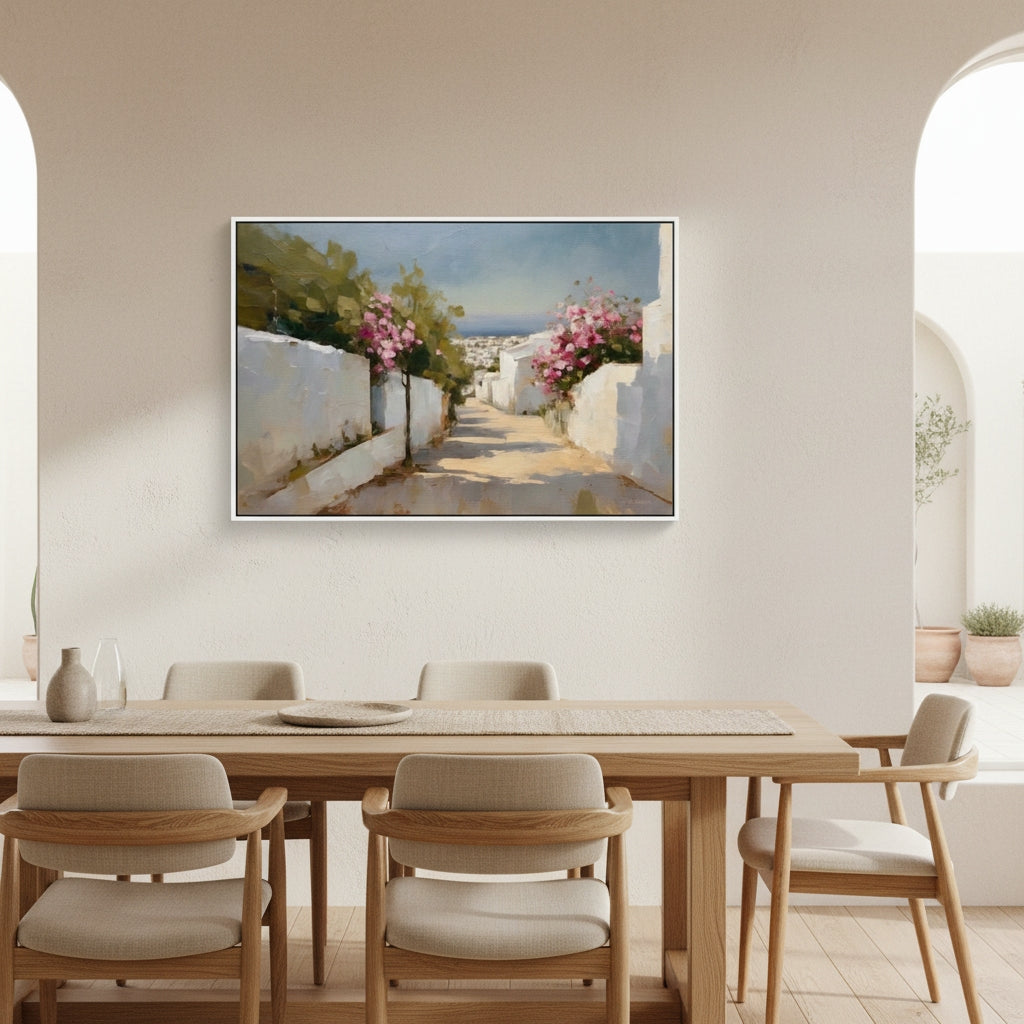 Dining room with a large painting of a white-walled street with flowers on the wall.