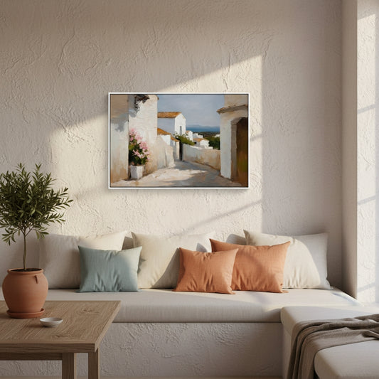 Living room with a sofa, cushions, a plant, and a framed picture on the wall.