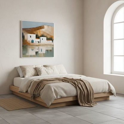 Neatly made bed in a room with a painting on the wall and a window.