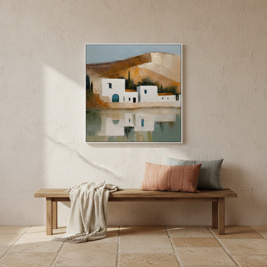 Framed artwork of a coastal scene above a wooden bench with cushions.