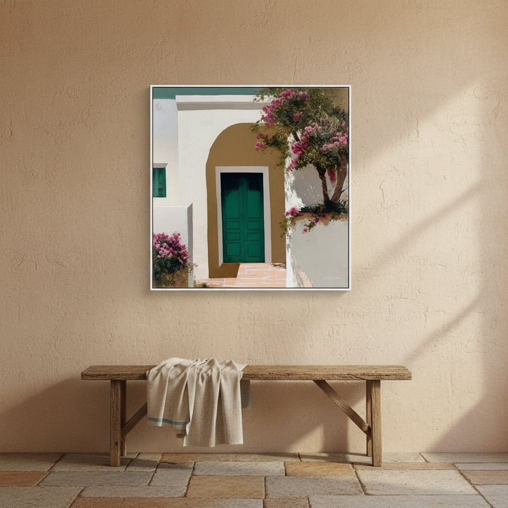 Framed artwork of a Mediterranean scene with a wooden bench below on a beige wall.