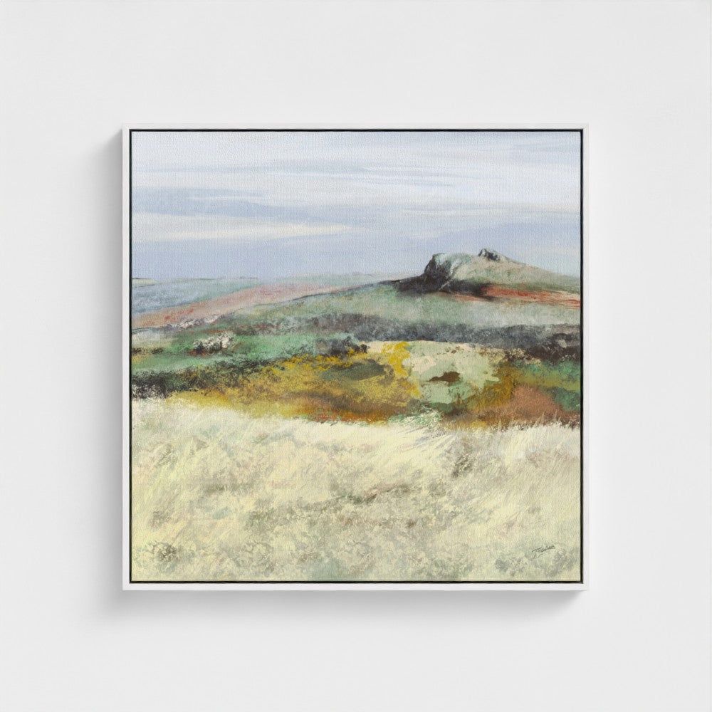 Framed artwork of a landscape with a hill and open field on a white background
