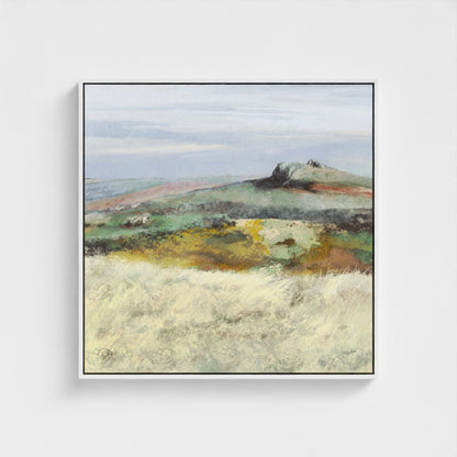 Framed artwork of a landscape with a hill and open field on a white background