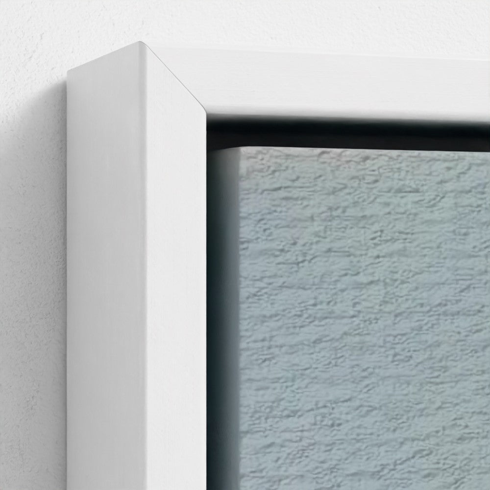 Close-up of a white frame corner with a textured light blue wall background