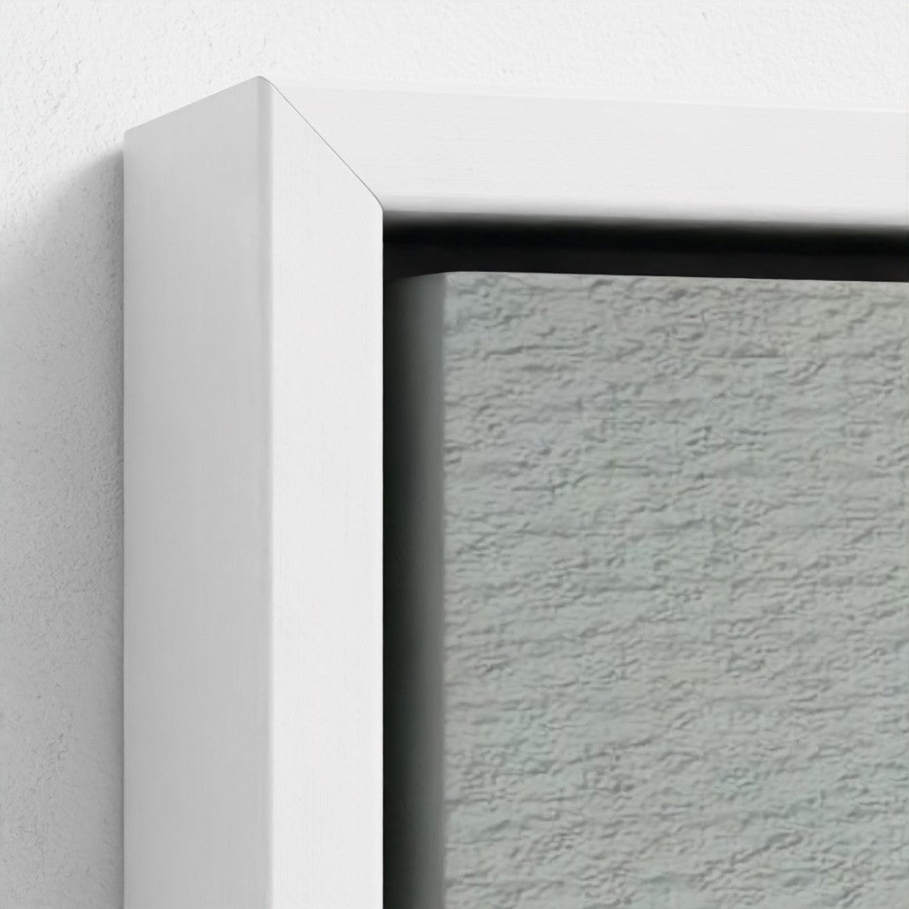 Close-up of a textured gray wall with a white frame corner.