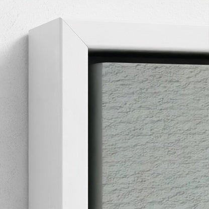 Close-up of a textured gray wall with a white frame corner.