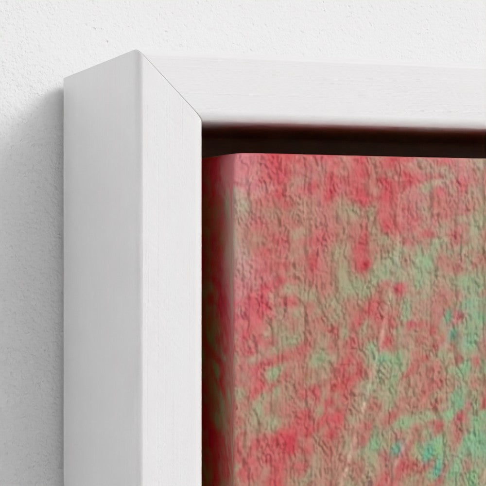 Framed abstract artwork with pink and green patterns on a white wall.