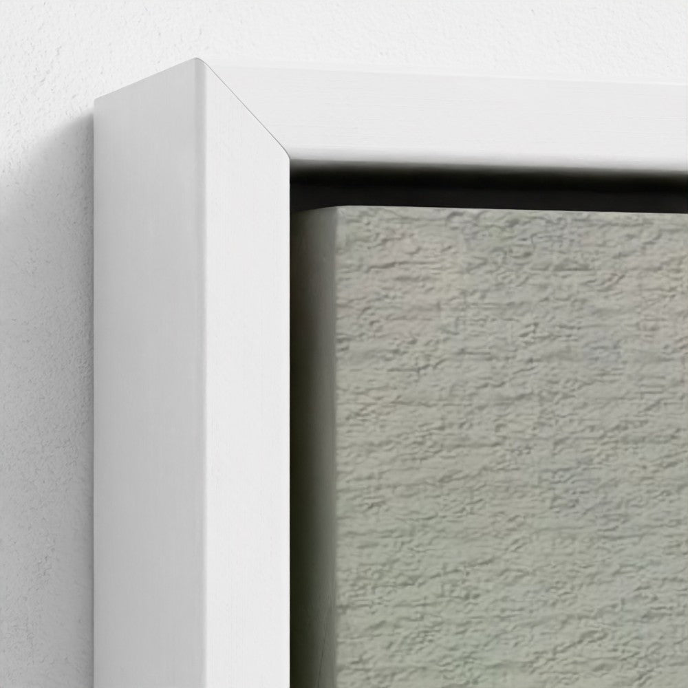 Close-up of a textured gray wall with a white frame corner.